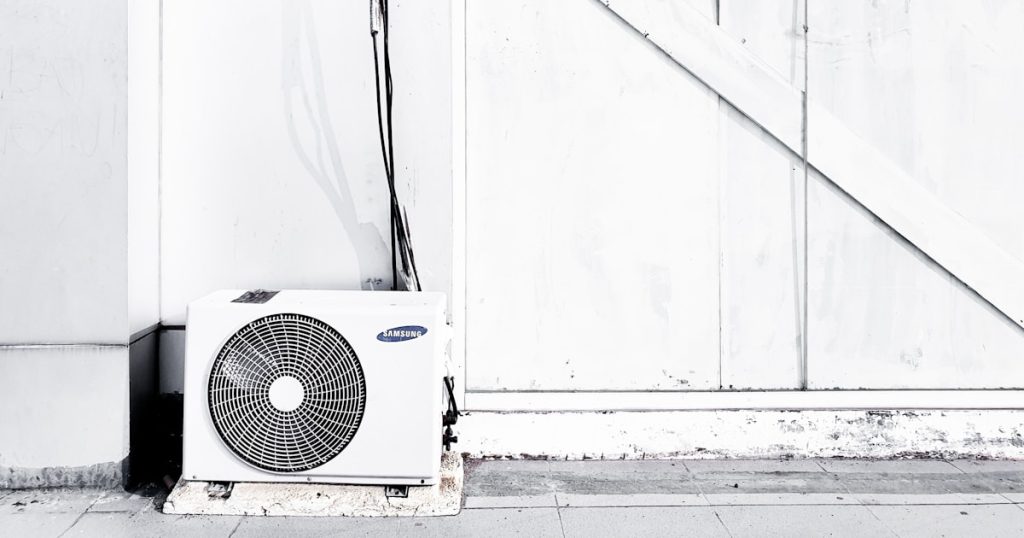 grayscale photography of outdoor AC unit