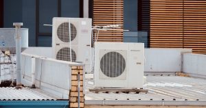 white and gray box fan on brown wooden table