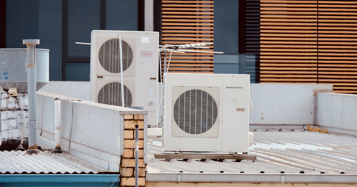 white and gray box fan on brown wooden table