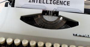 white and black typewriter with white printer paper
