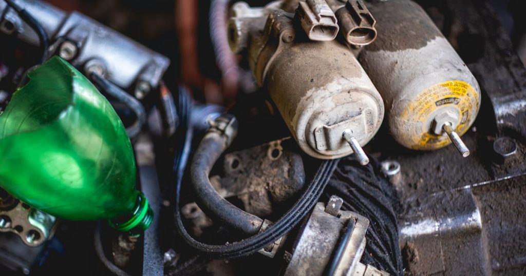 a close up of a car engine with a green light