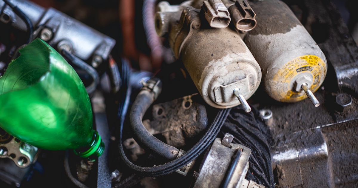 a close up of a car engine with a green light