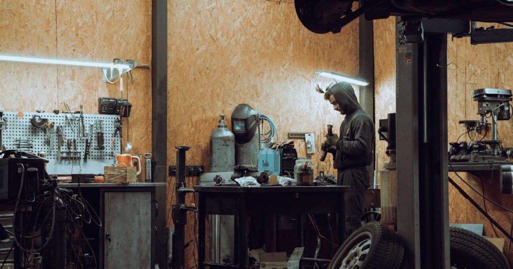 a man working on a machine in a garage