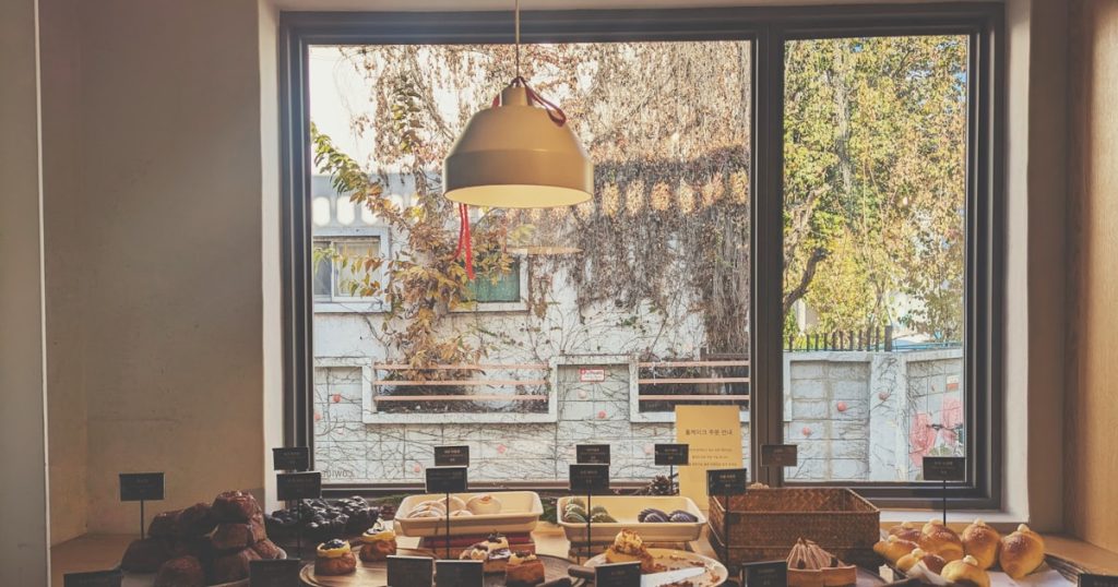A table filled with lots of food next to a window