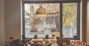 A table filled with lots of food next to a window