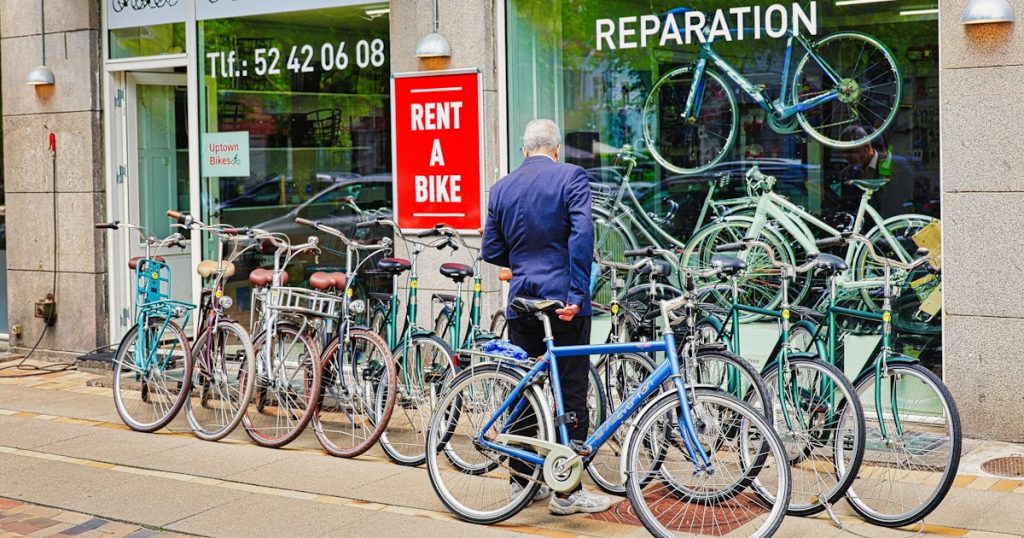 Man looking at bicycles outside a rental shop