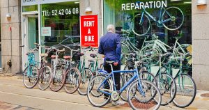 Man looking at bicycles outside a rental shop
