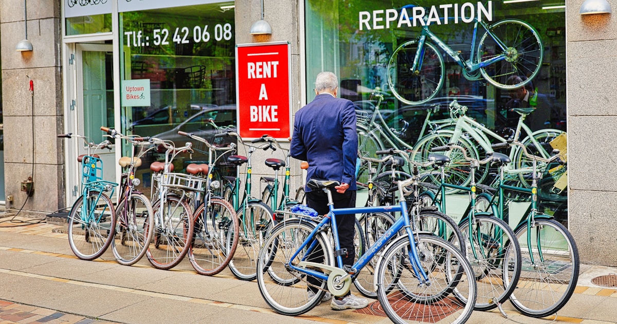 Man looking at bicycles outside a rental shop
