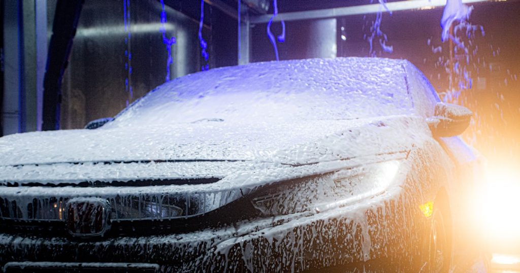 a car is covered in ice and water