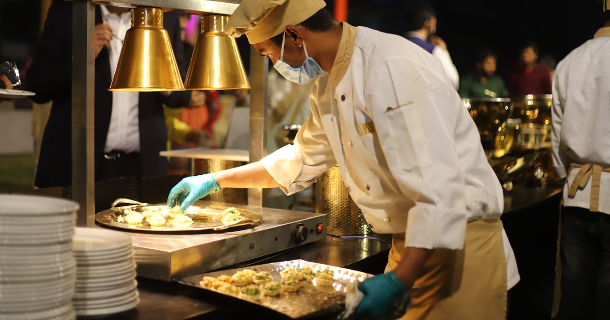 man in white chef uniform cooking