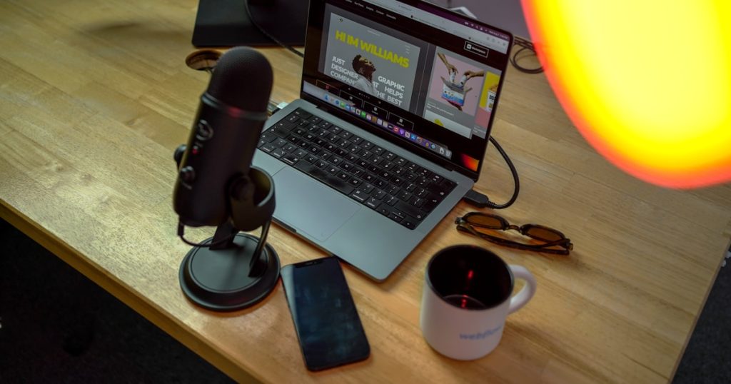 a laptop computer sitting on top of a wooden desk