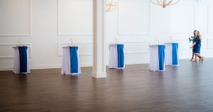 Empty event space with decorated high-top tables