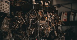 a bunch of engine parts sitting on top of a shelf