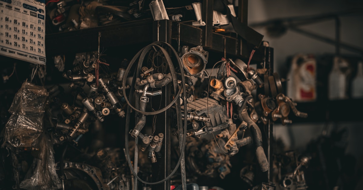 a bunch of engine parts sitting on top of a shelf