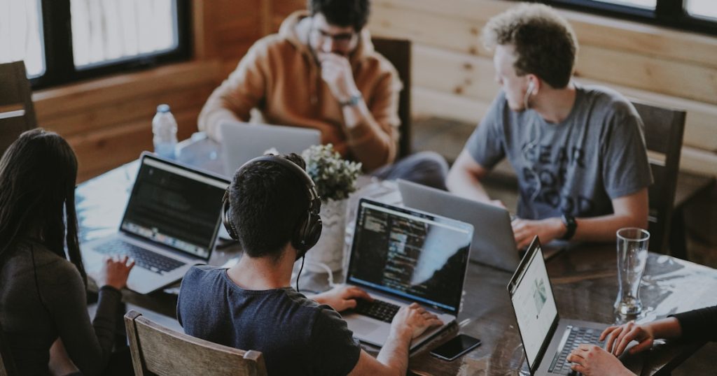 group of people using laptop computer