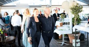 Couple walking together at an event with guests