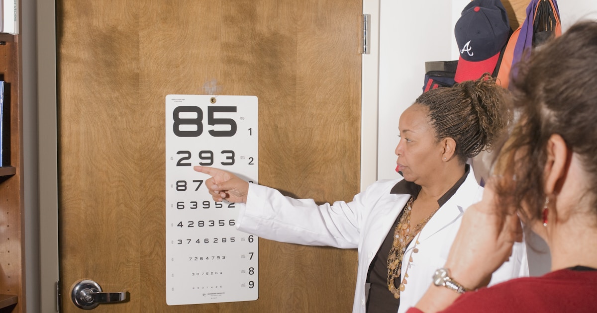 a woman pointing at a sign on a door