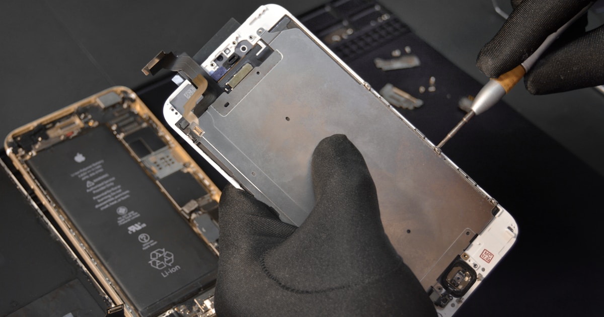 person fixing phone