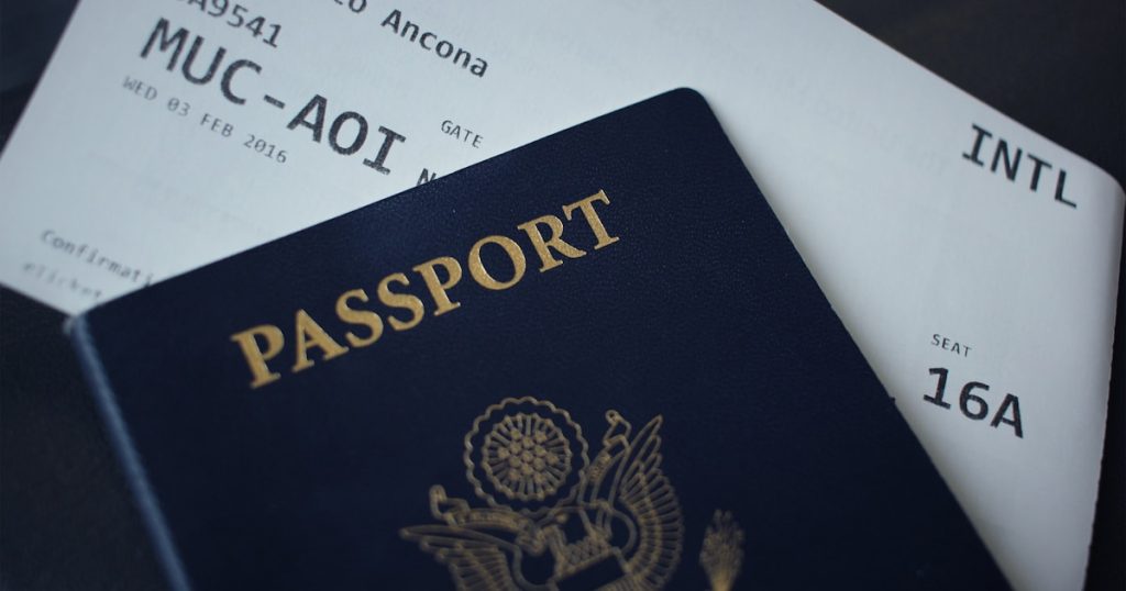 passport booklet on top of white paper