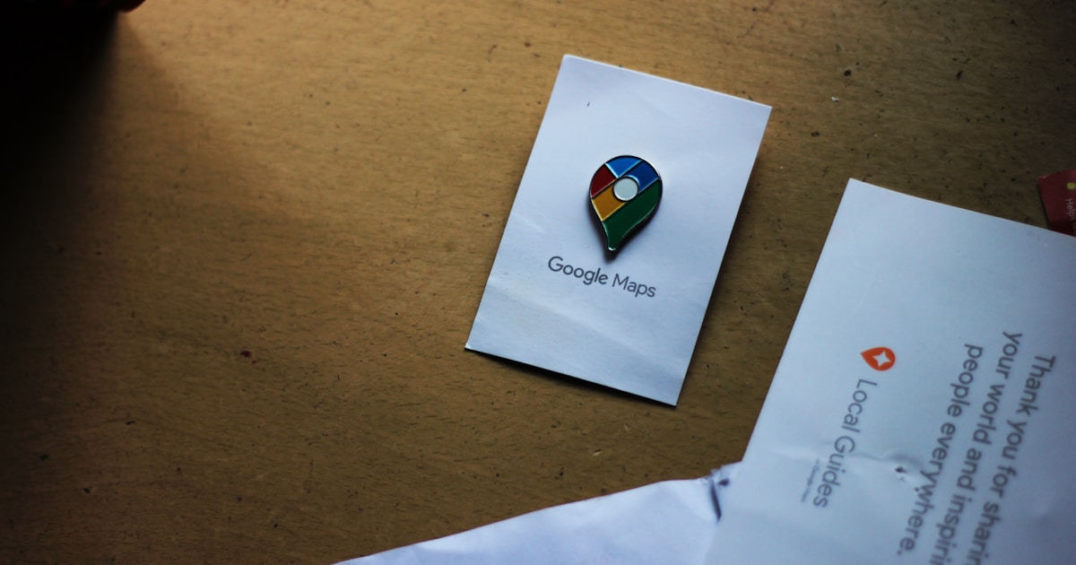 a google maps pin sitting on top of a piece of paper