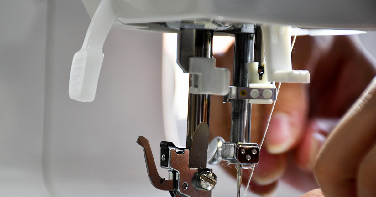 person using sewing machine in tilt shift lens