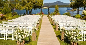 white folding chair in front of body of water