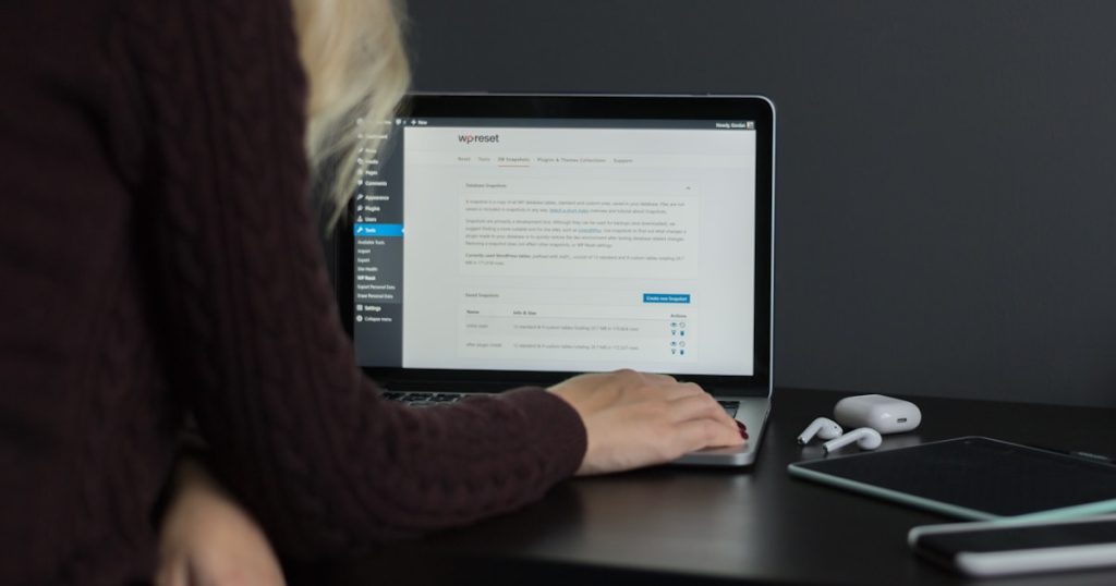 woman in black sweater using macbook pro