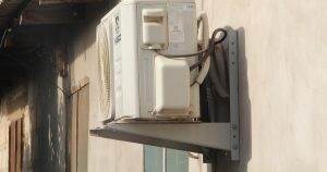 a white phone mounted to the side of a building