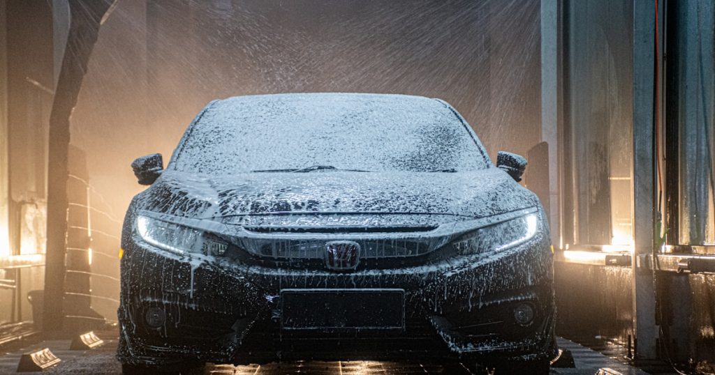 a car is covered in snow in a garage