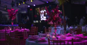 a table set up for a party with candles and flowers