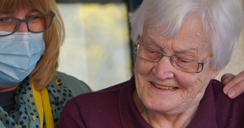 woman in purple polo shirt wearing eyeglasses