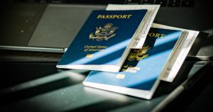 a passport sitting on top of a computer keyboard