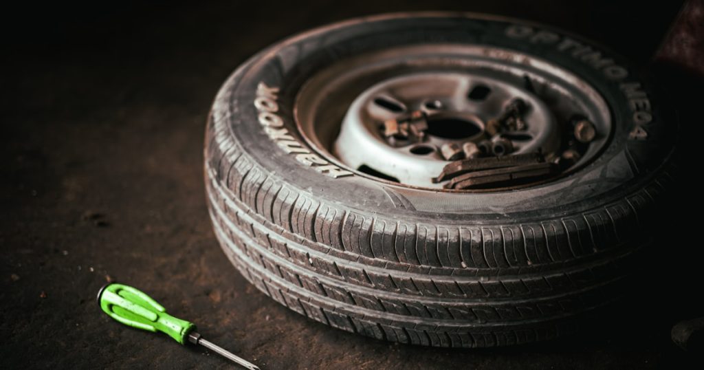 a tire with a wrench next to it