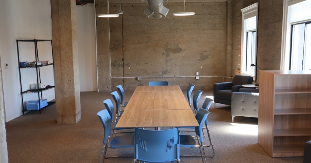 Empty conference room with a long table and chairs