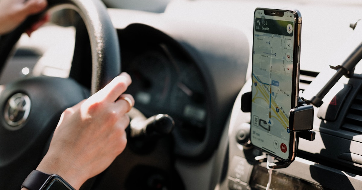 a person using a cell phone while driving a car