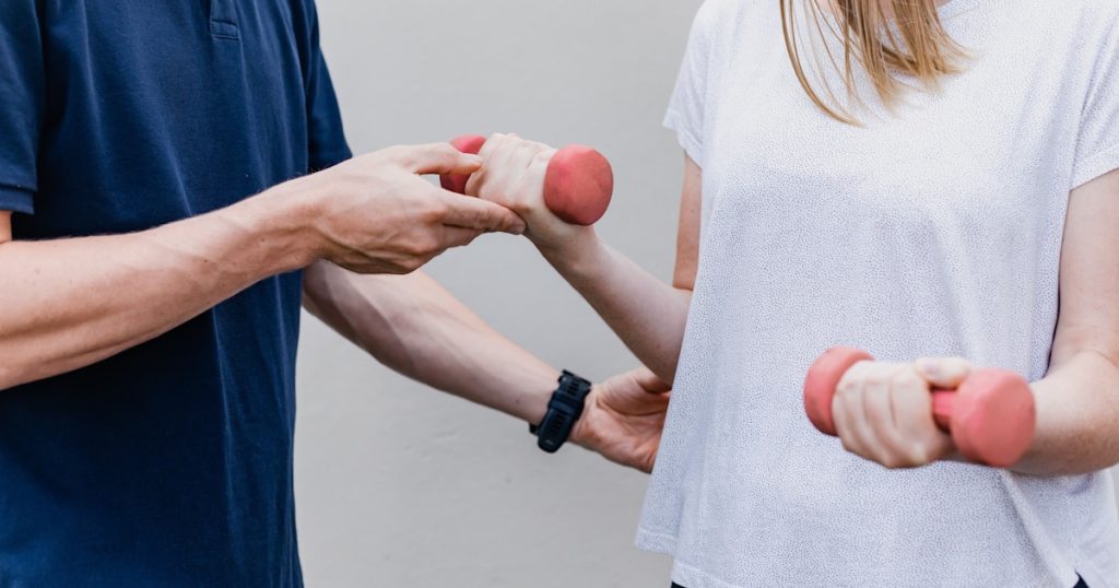 a man and a woman holding dumbs in their hands