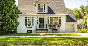 white house with green lawn and trees