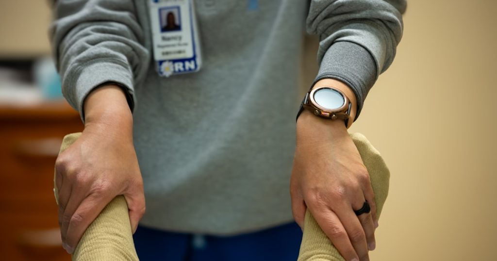 A nurse is performing physical therapy.