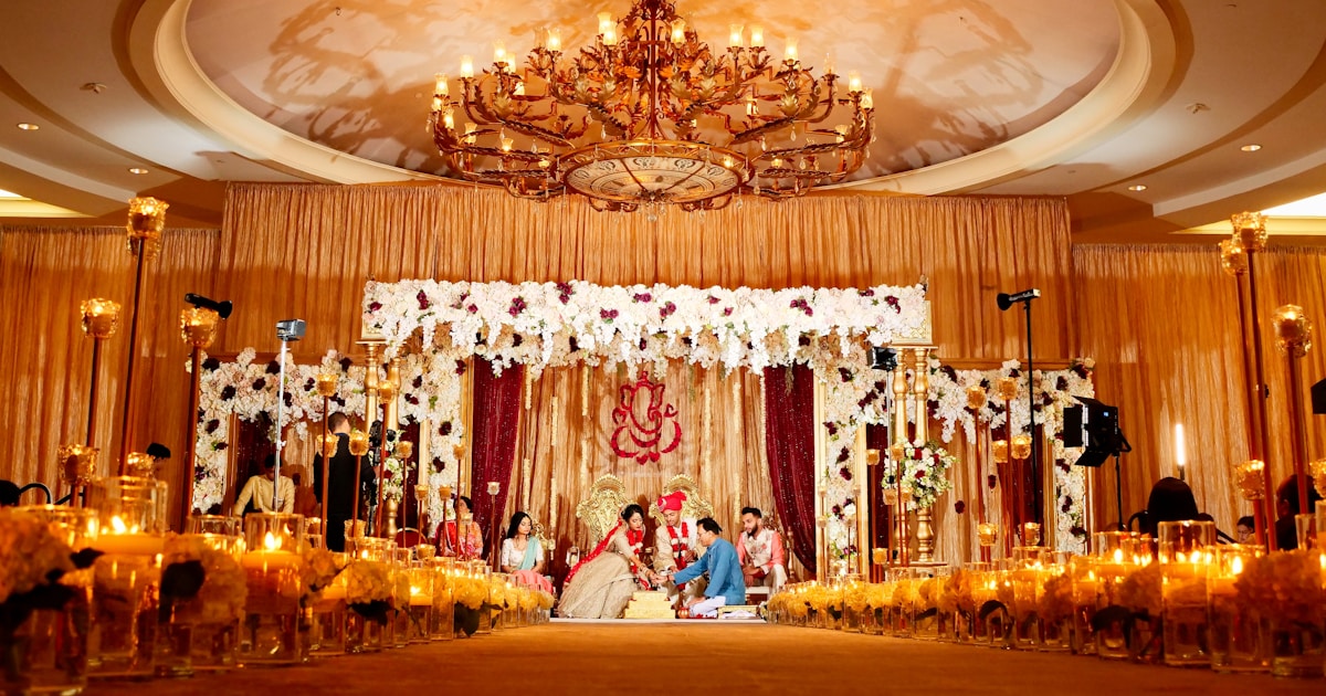 people standing in gold and white floral ceiling