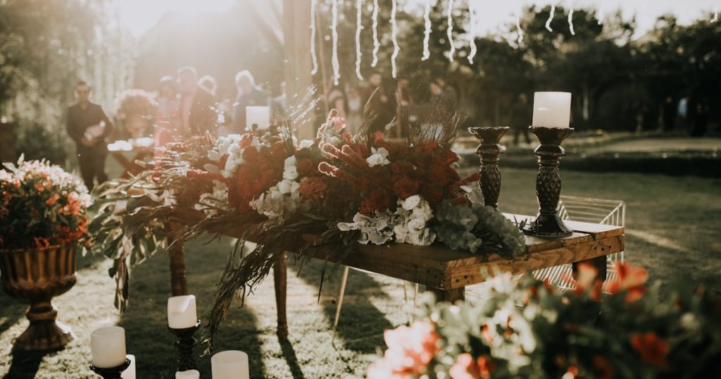 assorted-color flower decors on table with candle holders