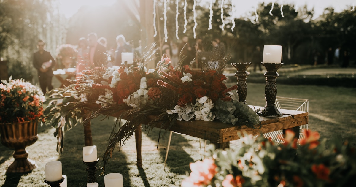 assorted-color flower decors on table with candle holders